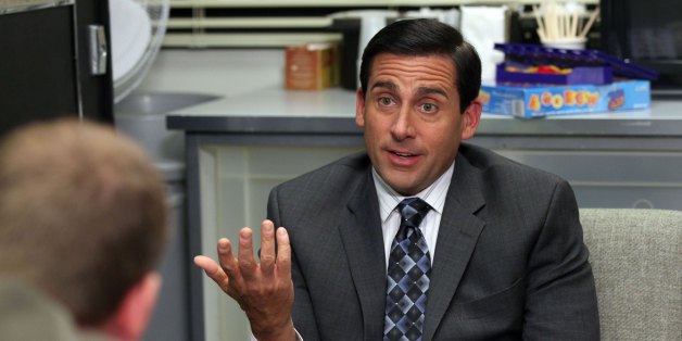 Michael Scott talks with coworkers
